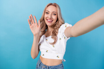 Sticker - Photo of charming excited woman dressed white top waving arm hi recording video vlog isolated blue color background