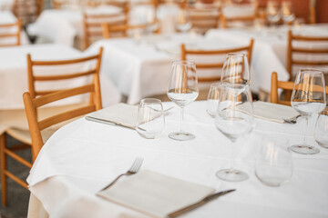 Tables with clean dishes in the restaurant are set for receiving guests - siesta and the restaurant is closed