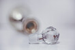 Intentional soft focus image of an old antique perfume bottle with an ornate perfume dispenser as the lid, space for text