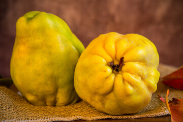 Wall Mural - Ripe natural autumn quince on wooden table.