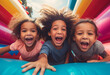 Capture the joyous energy of group of mix races afro American children at playing bouncing and laughing in an inflatables bouncer castle, Kids on the inflatable bounce house