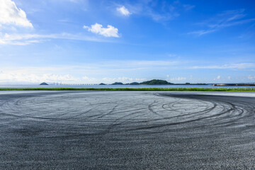 Race track road and coastline landscape under blue sky