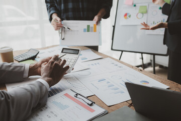 Wall Mural - Group of businessmen working together to calculate income, They are revising the financial numbers, Take out financial documents and check them with a calculator, financial idea.