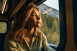 © MAXSHOT_PL - Young Blond Woman Gazing Out Train Window on Her Journey. The psychology of accepting yourself, your individuality. Generative Ai.