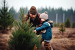 Father and son buying a christmas tree on a plantage in forest