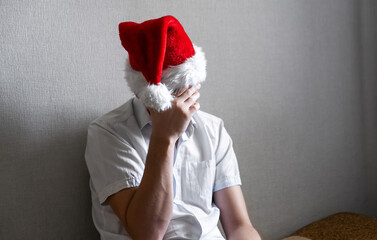 Wall Mural - Sad Young Man in Santa Hat