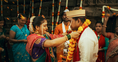 Authentic Slow-Motion Footage of Traditional Indian Wedding Customs: Groom and Bride Being Celebrated by Happy Friends and Family Throwing Flowers, Singing, Witnessing a Union Built on Love