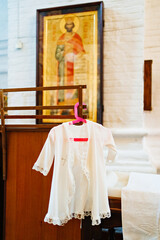 Sticker - Baptismal dress on a hanger in the church. 