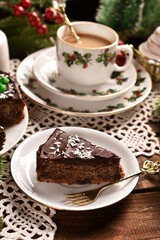 Poster - Christmas poppy seed cake with chocolate glaze and a cup of coffee on festive table