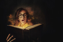 Portrait Of A Scared Woman Opening A Book With Pages On Fire