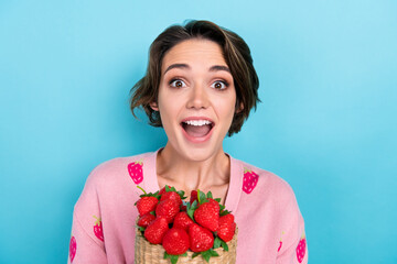 Wall Mural - Photo of astonished cheerful pretty woman dressed stylish clothes hold red sweet tasty berries yummy isolated on blue color background