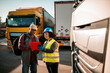 © Marko Geber - Safety supervisor discussing procedures with a truck driver