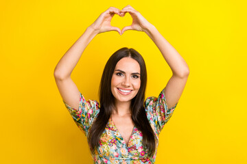 Poster - Photo of nice pretty lady wear trendy clothes two arms above head show heart symbol isolated on vivid yellow color background