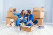 © gorynvd - Young couple taking selfies in their new home while sitting among cardboard boxes. Happy attractive young couple is moving, making a selfie, cuddling and smiling.