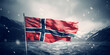 Tattered Norway flag flutters in wind on flagpole in snowstorm against backdrop of northern sea and mountain peaks