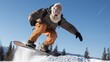 © AnaV - Happy looking senior man performing on a snowboard