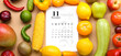 Calendar with marked date NOVEMBER 1, different vegetables and fruits on beige background