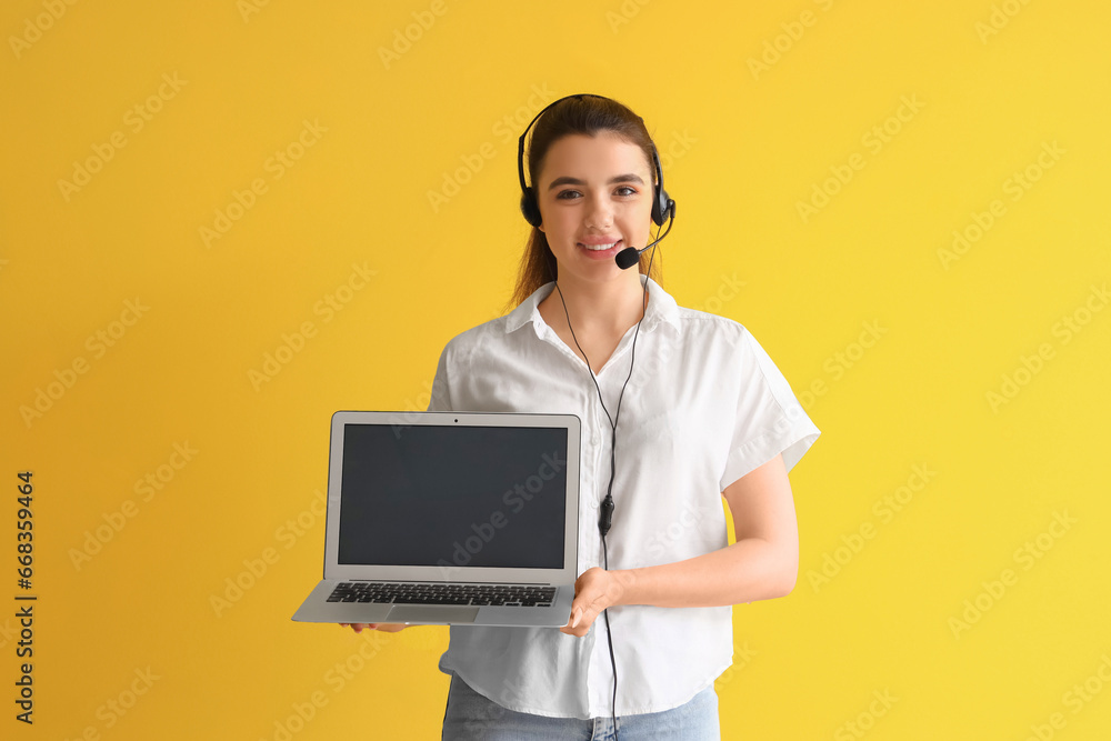 Female technical support agent with laptop on yellow background
