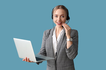 Wall Mural - Female technical support agent with laptop on blue background