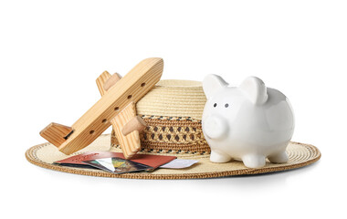 Sticker - Piggy bank with wooden toy airplane, wicker hat and passport on white background. Concept of savings for travel