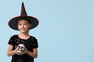 Sticker - Cute little girl dressed for Halloween as witch with human skull on blue background