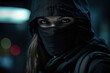 A woman wearing a black mask and a black hood. This image can be used to depict mystery, anonymity, or a hidden identity