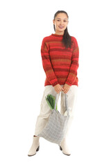 Wall Mural - Young Asian woman with eco bag full of fresh food isolated on white background