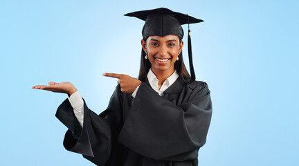 Poster - Graduation, portrait and happy woman point, palm gesture and advertising learning, university info or college study. Studio mockup space, student commercial ads or school graduate on blue background