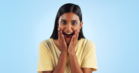 Wall Mural - Excited, woman and crazy portrait with wow, surprise and winner with a smile in a studio. Blue background, happy and celebration with female person shocked from omg announcement and achievement