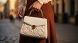 Grasping a timeless handbag with style and grace