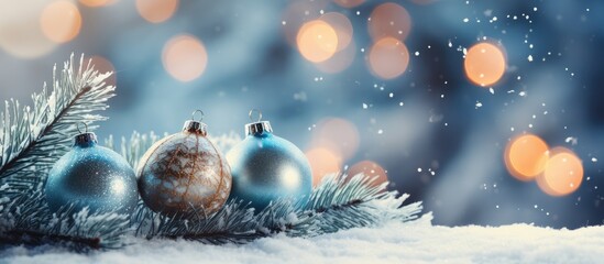 Poster - Snow covered Christmas tree branch with selective focus on blue shiny decoration while New Year tree has balls garlands and de focused Xmas lights on a blurred sparkling background