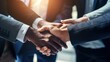 © Phoophinyo - Top view of business team shaking hands, covering hands, hands joining forces together.