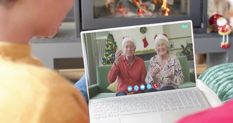 Poster - Happy caucasian couple and senior parents having christmas laptop video call, slow motion