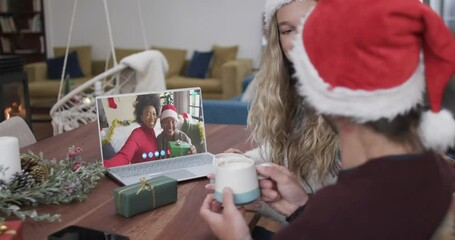 Poster - Happy diverse couple and mother with daughter having christmas laptop video call, slow motion