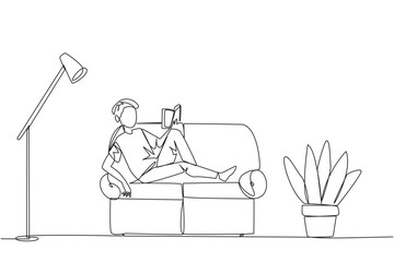 Wall Mural - Single continuous line drawing man sitting stretched out on the sofa reading book. Really like the content of the book reading on each page. Impressive. Love read. One line design vector illustration