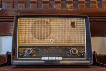 Antique radio on vintage background, Photo of a brown vintage radio with wooden casing.