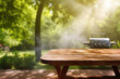 © vefimov - Wooden table with grill in background. Perfect for outdoor cooking and barbecues.