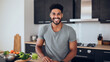 © AspctStyle - Attractive smiling young man on kitchen counter with vegetables preparing delicious food