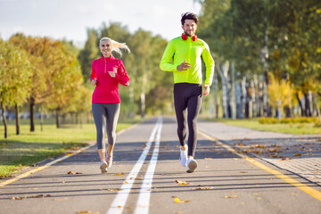  Sport Concepts. Positive Running Couple During Happily Jogging Outside as Runners Training Outdoors Working Out in City As Fitness Couple.