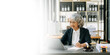 © Nuttapong punna - Senior asian woman lawyer working and gavel, tablet, laptop in front, Advice justice and law concept.