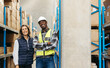 © Jacob Lund - Cheerful warehouse workers smiling while standing together