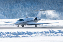 Luxury Business Jet Taking Off In Engadin Valley In The Swiss Alps. The Airport Of Samedan Is Used By Wealthy People To Get To Their Ski Vacations In Winter. This Airplane Did No De-icing Before Dep.