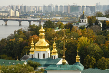 Wall Mural - Panoramic view of Kyiv Pechersk Lavra churches, the Dnieper river and high buildings in Kyiv, Ukraine. October 23, 2023