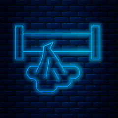 Poster - Glowing neon line Broken metal pipe with leaking water icon isolated on brick wall background. Vector