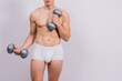© Ivan Zelenin - Shirtless bodybuilder holding dumbell and showing his muscular arms.