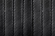 Fake leather texture. Closeup fabric. Black leather imitation stripes. Textile lines pattern. Shiny artificial leather.