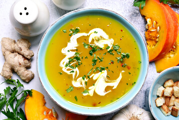 Wall Mural - Autumn pumpkin soup with ginger and garlic. Top view with copy space.