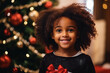 a little african girl with a christmas tree in the background
