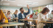 © Gorodenkoff - Diverse Mature Students Learning in Classroom, Writing Exam Answers in Notebooks. Young Indian Man Raising Hand and Asking Teacher a Question During a Lecture in Adult Education Course in School