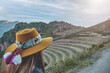 traveler hipster girl in hat with backpack exploring Pisac Archaeological Complex which was built by Incas in Sacred Valley of Peru.